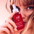 Applying Intense Anti-Aging Serum on face for wrinkle smoothing